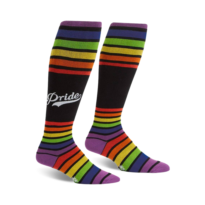 Pair of rainbow striped knee-high socks with a retro 'Pride' logo on a black background.  Purple, orange, yellow, green, and blue stripes.