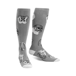 Pair of gray knee-high socks with a whimsical anatomical design. Features skulls, ribcages, and hearts in grayscale.
