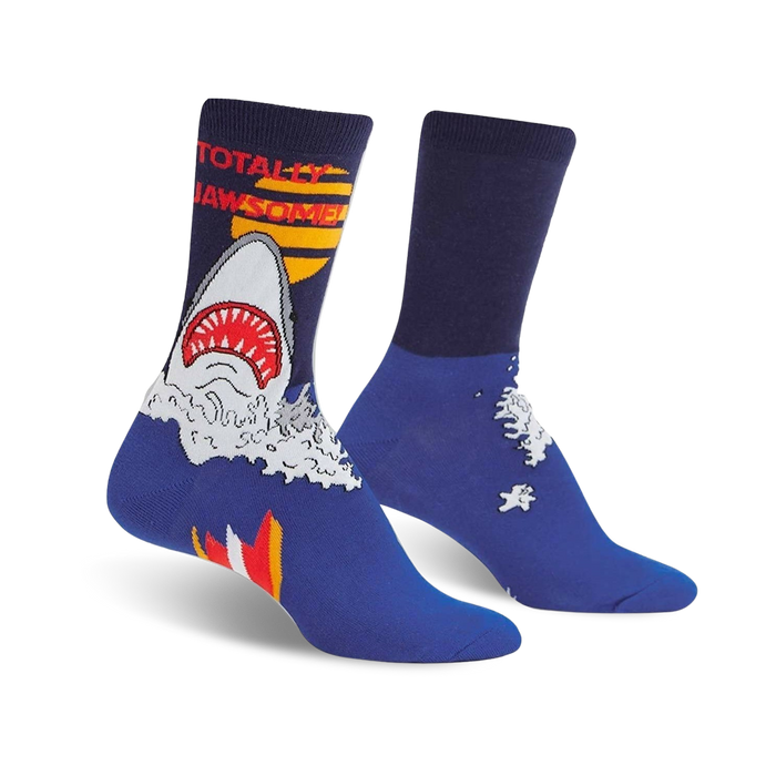 A pair of blue crew socks with a graphic design of a great white shark emerging from the water, text says 'Totally Jawsome'. }}
