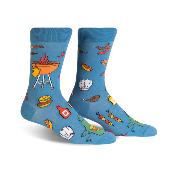 blue crew socks with bbq grilling-related items, including a grill, hot dogs, hamburgers, a chef's hat, tongs, and ketchup and mustard bottles.   