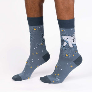 Lifestyle shot showcasing Cosmic Cetacean socks on a person's feet, highlighting the sock's fit and design.