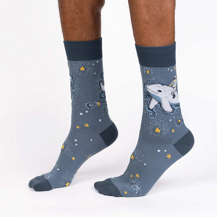 Lifestyle shot showcasing Cosmic Cetacean socks on a person's feet, highlighting the sock's fit and design.