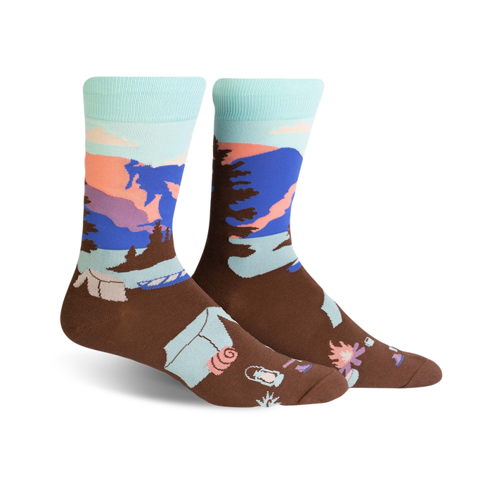 Brown crew socks with a pastel Glacier National Park scene. Features mountains, trees, and camping icons. }}