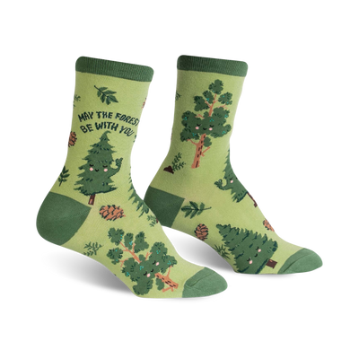 Crew socks in green and brown featuring happy cartoon trees, pine cones, and leaves. The text 'May the Forest Be With You' is on one sock.