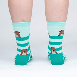 Back view of the otter socks on a model, showing the design on the back of the socks.