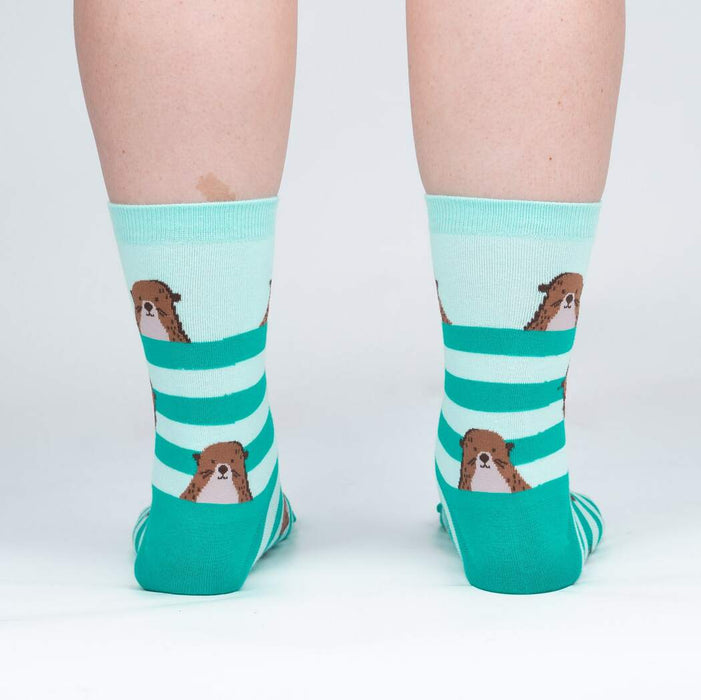 Back view of the otter socks on a model, showing the design on the back of the socks.