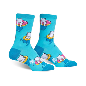 Crew socks in teal featuring a pattern of white cats riding pink donut inner tubes.