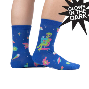 Lifestyle shot of a person wearing the InterGalactic Reading List socks, showing how they look on feet.