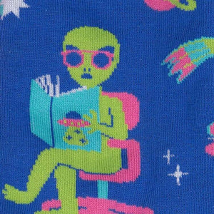 Close-up detail shot of the alien reading a book, highlighting the design's fine details.