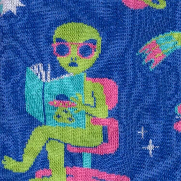 Close-up detail shot of the alien reading a book, highlighting the design's fine details.