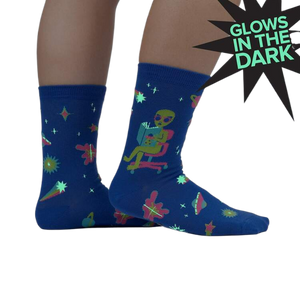 Lifestyle shot of the socks glowing in the dark, highlighting the glow-in-the-dark feature.