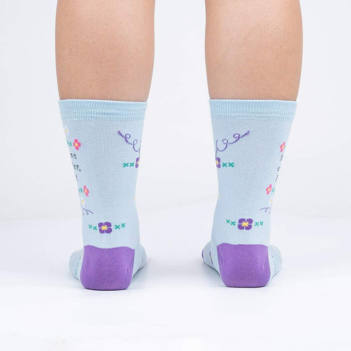 Rear view of the socks on a person's feet, showcasing the back design and the purple heel and toe.