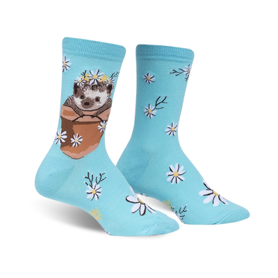 Pair of light blue crew socks featuring a cute hedgehog in a flower pot wearing a daisy crown, surrounded by smaller daisies.