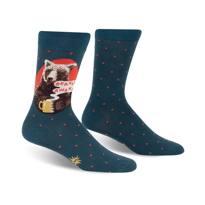 Pair of teal crew socks with a design of a bear drinking coffee.  Red and orange accents and small teal dots are also featured.