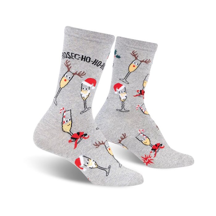 Pair of grey crew socks with a festive design. Features champagne glasses wearing Santa hats and reindeer antlers, along with candy canes and holly. }}