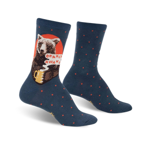 A pair of teal crew socks with a brown bear drinking coffee and the words 'Bearly Awake'.  Red accents and small red polka dots decorate the socks.