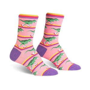 Crew socks in pink, purple, and yellow, featuring a pattern of green dinosaurs roller-skating.