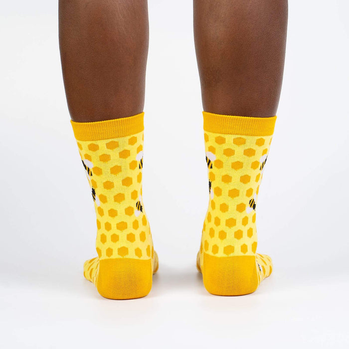 Rear view of the yellow honeycomb bee socks on a model.