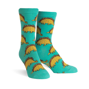Teal crew socks with a repeating pattern of cute dinosaurs made of tacos.