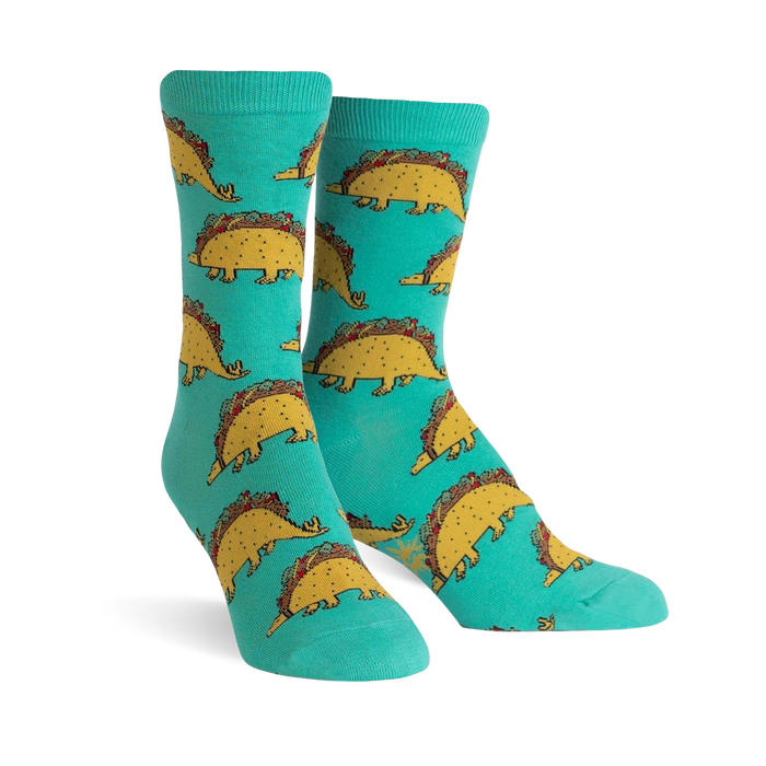 Teal crew socks with a repeating pattern of cute dinosaurs made of tacos.