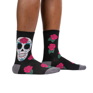 Lifestyle shot: A person's legs wearing the Sugar Skull socks, showcasing how they look when worn.