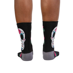 Rear view of the Sugar Skull socks on a person's legs. Shows the back design.