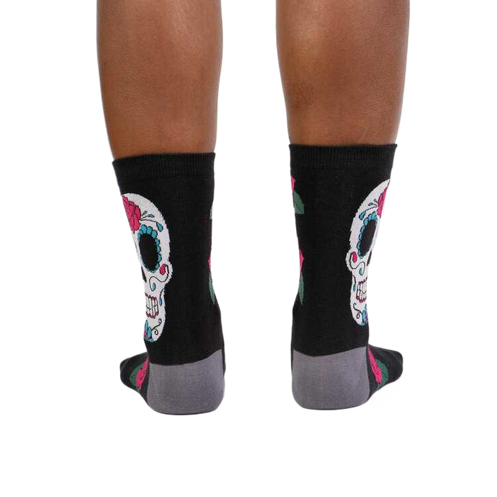 Rear view of the Sugar Skull socks on a person's legs. Shows the back design.