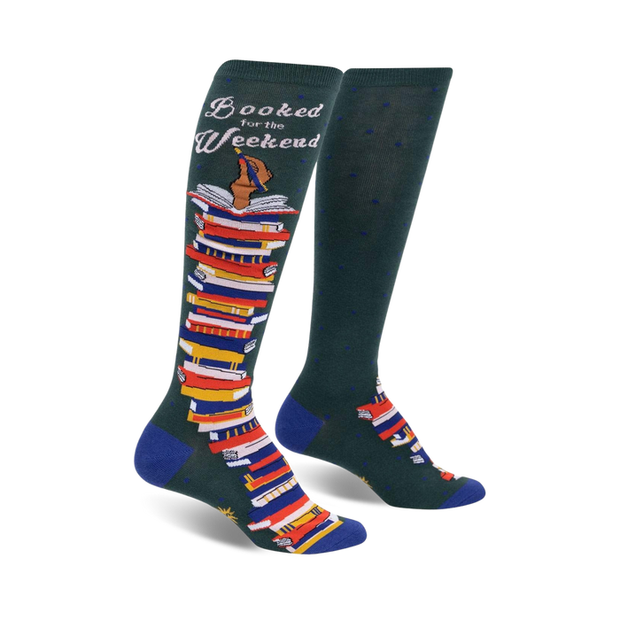 Pair of dark green knee-high socks with a colorful stack of books and the text 'Booked for the Weekend'. Blue accents at the cuffs.
