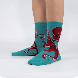 A pair of teal socks with a red octopus wearing glasses on each sock.