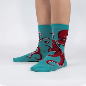 Lifestyle shot showing The Octive Reader socks on a person's feet, showcasing the fit and teal color.