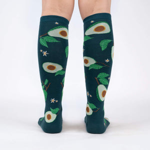 Back view of the teal avocado knee-high socks on a person's legs.
