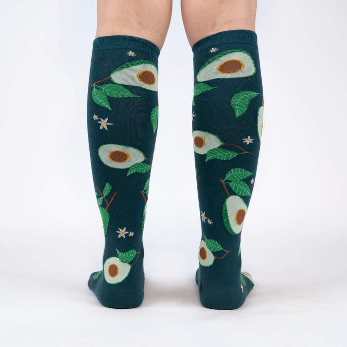 Back view of the teal avocado knee-high socks on a person's legs.