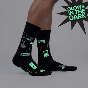 Close-up of the 'Game On' socks, highlighting the glowing details in the dark. The image emphasizes the glow-in-the-dark feature.