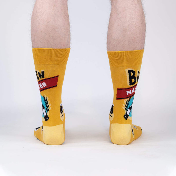 A pair of yellow socks with a beer mug and the words 