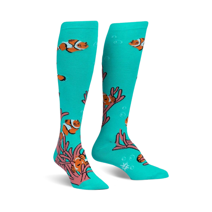 Pair of teal knee-high socks with a playful design of orange clownfish swimming among pink coral.