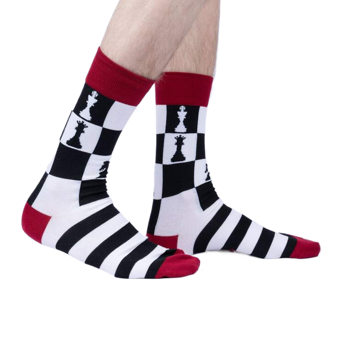 Lifestyle shot of a person wearing a pair of Lucky You socks. The socks are black, white, and red.