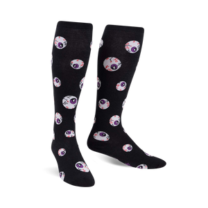 Pair of black knee-high socks with a repeating pattern of purple and red glow-in-the-dark eyeballs.