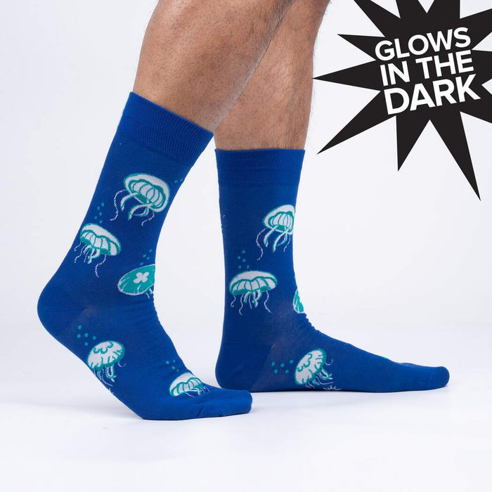 Lifestyle shot of a person wearing the 'Nice to Sea You' glow-in-the-dark jellyfish socks.