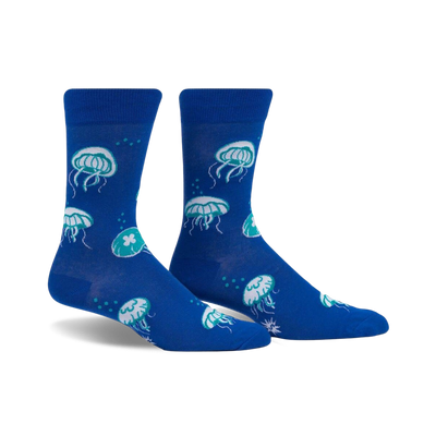 Pair of blue crew socks with a fun jellyfish pattern in teal and white. The socks glow in the dark!