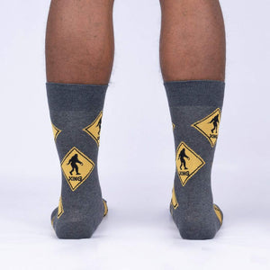 Back view of the Bigfoot Xing socks on a person's legs, showcasing the full sock design.