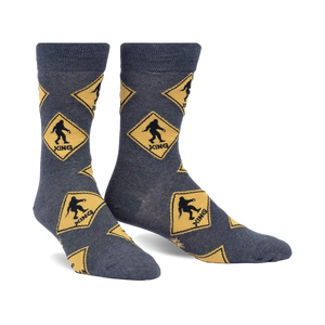 Crew socks in grey with a repeating pattern of yellow diamond-shaped Bigfoot crossing signs. Fun, quirky design.