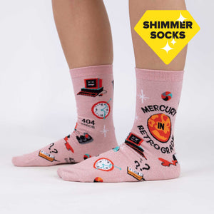 A pair of pink knee-high socks with a pattern of retro rockets, planets, and stars on a light pink background.