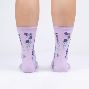 Rear view of the socks on a person's legs against a white background.