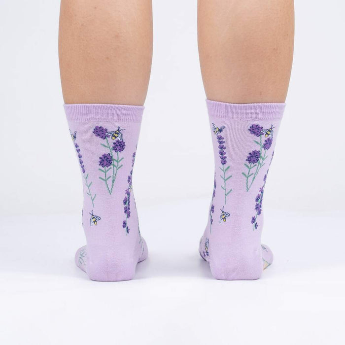 Rear view of the socks on a person's legs against a white background.