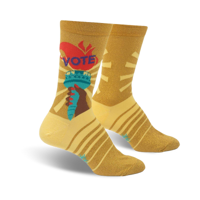 Crew socks in gold with a vibrant Statue of Liberty graphic, 'VOTE' text, and yellow-gold stripes.