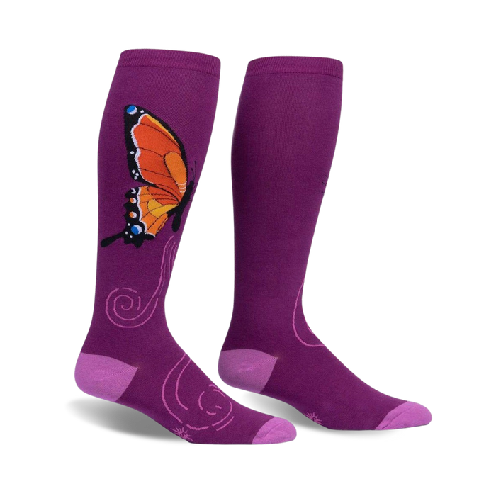 women's monarch socks in purple feature a pattern of orange, black, and blue butterflies with a flower.  