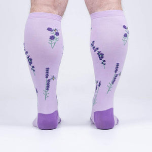 Rear view of the socks on a person's legs, highlighting the back design details.