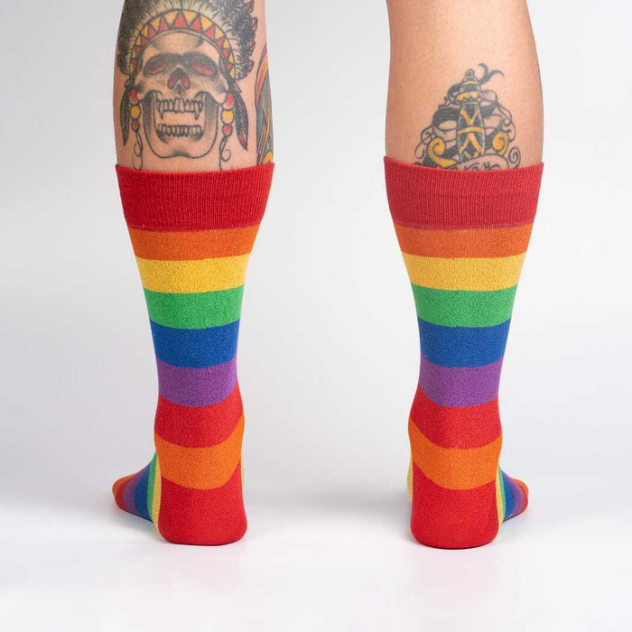 Rear view of the rainbow shimmer socks on a person's legs.