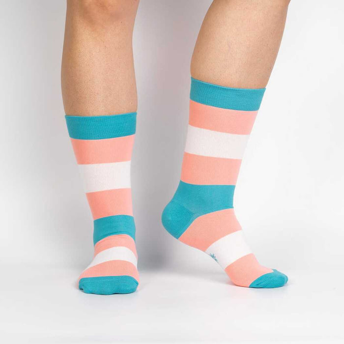 Flat lay of Trans Pride socks showing details of the design and colors.