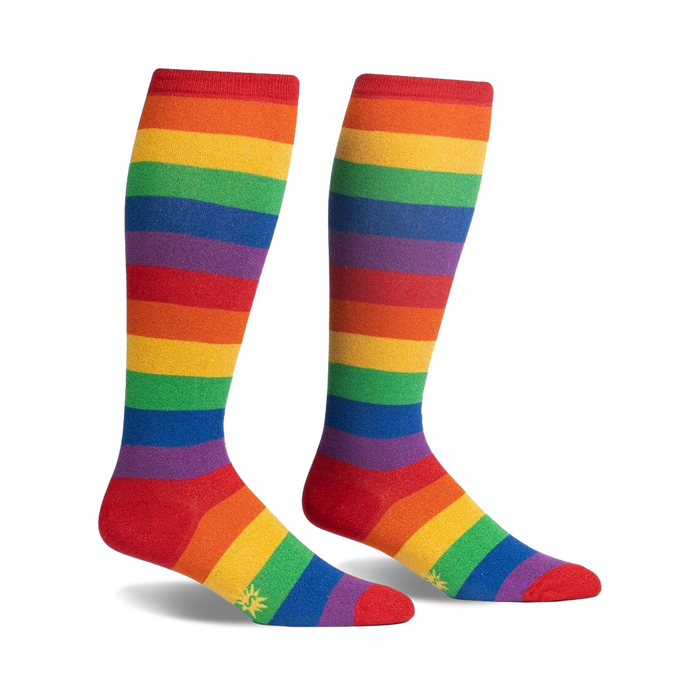 Pair of rainbow striped knee-high socks.  Red, orange, yellow, green, blue, indigo, and violet stripes. Small sun logo near the toes.